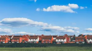 Modern residential brick houses in the United Kingdom set against a blue sky.