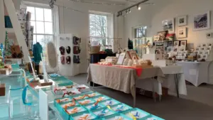 Bright, modern gift shop interior featuring handcrafted glass ornaments and local artistic displays.