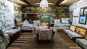 An atmospheric room filled with traditional embroidered textiles and antique folk art displays.