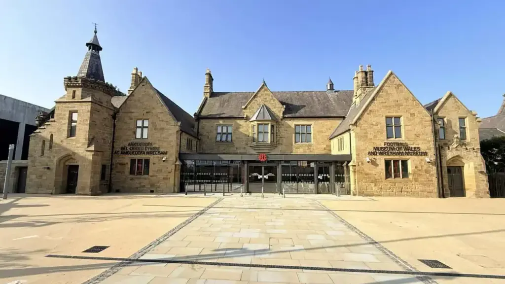 The historic Football Museum of Wales and Wrexham Museum building on a sunny day.
