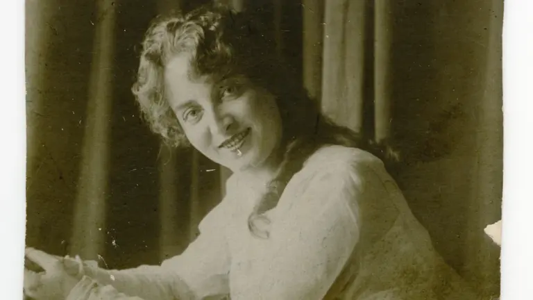 Vintage black and white portrait of a woman in a long-sleeved shirt.