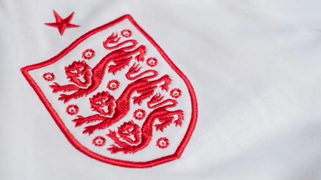 Close up of the embroidered England three lions crest on a white shirt.