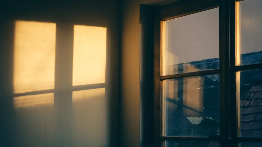 Bright morning sunlight streaming through a residential window into a peaceful room.