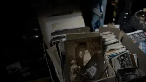 A box filled with old vintage black and white family photographs