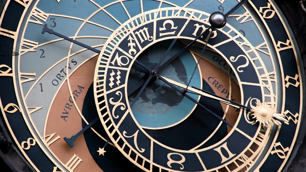 Close-up of the historical Prague Astronomical Clock dial showing intricate celestial details.